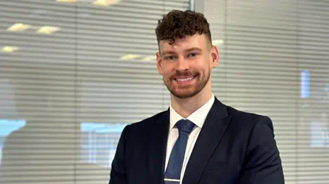 Systal Technology Solutions Calum Baird wearing a suit and smiling